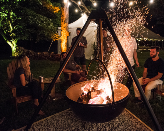 Burning Wood in Cauldron Surrounded by Friends